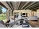 Open living room featuring beamed ceilings, hardwood floors, and sliding glass doors at 16440 Old Denver Rd, Monument, CO 80132
