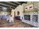Open-concept living room with stone fireplace, hardwood floors, and adjacent dining area at 16440 Old Denver Rd, Monument, CO 80132