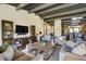 Spacious living room with dark wood floors, beamed ceilings, and comfortable furniture at 16440 Old Denver Rd, Monument, CO 80132