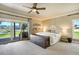 Bright main bedroom features a ceiling fan, private deck access, and outdoor views at 16440 Old Denver Rd, Monument, CO 80132