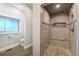 Tiled shower with a built-in bench and niche, alongside a separate toilet area with a window at 16440 Old Denver Rd, Monument, CO 80132
