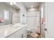 Bright bathroom featuring a vanity with solid surface counters, tub/shower with flamingo-themed decor at 6690 Mariposa St, Denver, CO 80221