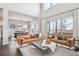 Well-lit living room with a fireplace, hardwood floors, and comfortable leather seating at 6690 Mariposa St, Denver, CO 80221