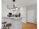 Modern kitchen with white cabinets, stainless steel appliances, granite countertops, and breakfast bar with seating at 2533 Central Park Blvd, Denver, CO 80238