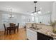 Open-concept kitchen and dining area with hardwood floors and natural light at 2533 Central Park Blvd, Denver, CO 80238
