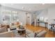 Bright living room featuring hardwood floors, neutral walls, large windows, and comfortable seating arrangement at 2533 Central Park Blvd, Denver, CO 80238