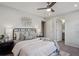 Comfortable bedroom features a ceiling fan, lamps, soft bedding and access to the bathroom at 2533 Central Park Blvd, Denver, CO 80238