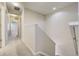 Hallway with neutral walls, carpet, and staircase leading to the upper level of the home at 3386 Valentia St, Denver, CO 80238