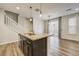 Granite kitchen island with ample cabinet space and stainless steel sink providing a stylish focal point for meal preparation at 3386 Valentia St, Denver, CO 80238