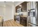 Modern kitchen featuring stainless steel appliances, dark cabinetry, granite countertops, and sleek hardware at 3386 Valentia St, Denver, CO 80238