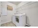 Functional laundry room with washer, dryer, and storage shelf at 3386 Valentia St, Denver, CO 80238