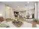Open-concept living room seamlessly connects the kitchen, dining area, and comfortable seating, perfect for modern living at 3386 Valentia St, Denver, CO 80238