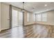 Spacious and bright room with a sliding door, large windows, and wooden floor at 3386 Valentia St, Denver, CO 80238