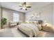 Comfortable main bedroom with ceiling fan, window, and neutral decor at 3386 Valentia St, Denver, CO 80238