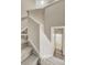Carpeted staircase leading to the upper level, adjacent to a hallway with access to a bathroom at 3386 Valentia St, Denver, CO 80238