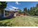 Well-maintained backyard featuring a spacious lawn, a patio, and a storage shed, ideal for outdoor activities and storage at 1229 W 102Nd Ave, Northglenn, CO 80260