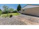 Large backyard with gravel, a small patio, mature trees and lawn at 1229 W 102Nd Ave, Northglenn, CO 80260