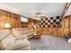 Finished basement with wood paneling, plush carpet, and comfortable seating area at 1229 W 102Nd Ave, Northglenn, CO 80260