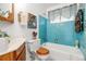 Charming bathroom featuring light blue tiles, oak-colored accents, and updated fixtures at 1229 W 102Nd Ave, Northglenn, CO 80260