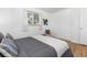 Bright bedroom featuring wood floors, large windows, closet, and minimalist decor at 1229 W 102Nd Ave, Northglenn, CO 80260