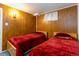 Small Bedroom showcasing matching beds with wood paneling and natural light at 1229 W 102Nd Ave, Northglenn, CO 80260