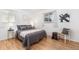 This bedroom boasts hardwood floors, neutral paint, and large windows for natural light at 1229 W 102Nd Ave, Northglenn, CO 80260