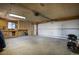 Expansive garage space featuring a workbench, overhead lighting and large garage door at 1229 W 102Nd Ave, Northglenn, CO 80260