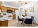 A full kitchen with tile floors, bright walls, and a breakfast nook with seating at 1229 W 102Nd Ave, Northglenn, CO 80260