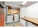 Convenient laundry room featuring a washer, dryer, and a practical folding table at 1229 W 102Nd Ave, Northglenn, CO 80260