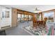 Open sunroom with a dining area, brick accent wall, and lots of natural light at 1229 W 102Nd Ave, Northglenn, CO 80260