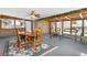 Enclosed sunroom with dining area, brick accent wall, and an abundance of sunlight at 1229 W 102Nd Ave, Northglenn, CO 80260
