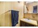 Clean bathroom with a vanity sink and vertical striped wallpaper at 7309 W Hampden Ave # 402, Lakewood, CO 80227