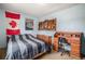 Spacious bedroom with striped bedding and built-in desk at 7309 W Hampden Ave # 402, Lakewood, CO 80227