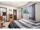 Comfortable bedroom with large window and wood furniture at 7309 W Hampden Ave # 402, Lakewood, CO 80227