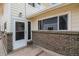 Brick building exterior with a walkway and entrance at 7309 W Hampden Ave # 402, Lakewood, CO 80227