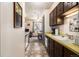 Kitchen with dark cabinets and yellow countertops at 7309 W Hampden Ave # 402, Lakewood, CO 80227