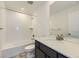 Bathroom featuring a shower-tub combo, white tile surround, modern fixtures, and a single vanity with storage at 918 Congress Pl, Elizabeth, CO 80107