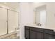 Modern bathroom with glass shower, gray cabinets, marble countertop, and contemporary fixtures at 918 Congress Pl, Elizabeth, CO 80107