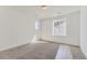 Bright, neutral bedroom featuring a large window, plush carpeting, and blank white walls for a customizable space at 918 Congress Pl, Elizabeth, CO 80107