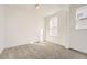 Bright bedroom features carpet, white walls, and a window providing natural light at 918 Congress Pl, Elizabeth, CO 80107