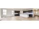 Open floor plan featuring a kitchen with dark cabinets, stainless appliances, an island, and light hardwood flooring at 918 Congress Pl, Elizabeth, CO 80107