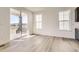 Open concept living space featuring light wood floors, sliding glass door to the porch, and big bright windows at 918 Congress Pl, Elizabeth, CO 80107