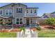 Charming townhome with stone accents, a covered porch, and a well-maintained lawn at 3338 Ireland Moss St, Castle Rock, CO 80109