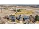 An aerial view of a neighborhood showcasing homes backing to a green space and fields at 618 S Carlton St, Castle Rock, CO 80104