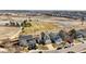 An aerial view of a neighborhood showcasing homes backing to a green space and fields at 618 S Carlton St, Castle Rock, CO 80104