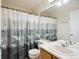 Bathroom featuring decorative shower curtain, sink, and toilet at 618 S Carlton St, Castle Rock, CO 80104