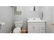 Cozy powder room featuring white fixtures and wood-look flooring at 618 S Carlton St, Castle Rock, CO 80104