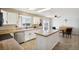 Bright kitchen featuring white cabinetry, a central island, modern appliances, and a cozy breakfast area at 618 S Carlton St, Castle Rock, CO 80104