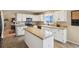 Bright kitchen featuring white cabinetry, a central island, modern appliances, and modern countertops at 618 S Carlton St, Castle Rock, CO 80104