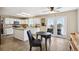 Bright kitchen featuring white cabinetry, a central island, modern appliances, and a cozy breakfast area at 618 S Carlton St, Castle Rock, CO 80104